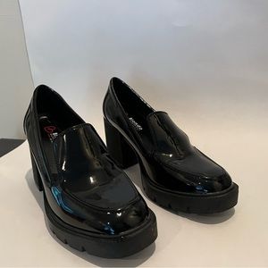 Blondo “Josie” lug sole loafers in black patent leather.